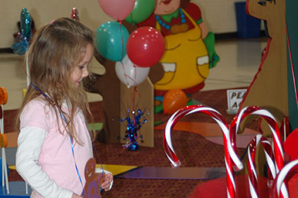 Little Girl with Big Candy Canes